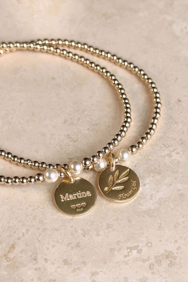 The perfect gift crafted in gold-plated silver and Preciosa pearls featuring an Olive Leaf motif on a Flowergirl motto charm and optional engraving.