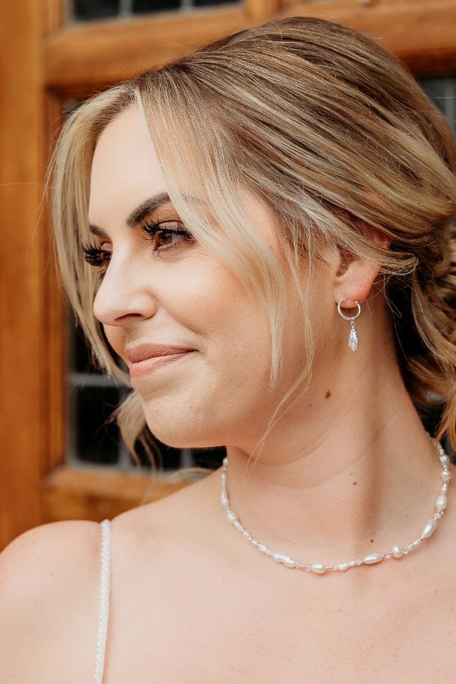 Reminiscent of a budding flower, these enchanting hoop earrings feature 925 Sterling Silver and Preciosa Pearls for a delicately detailed finish.