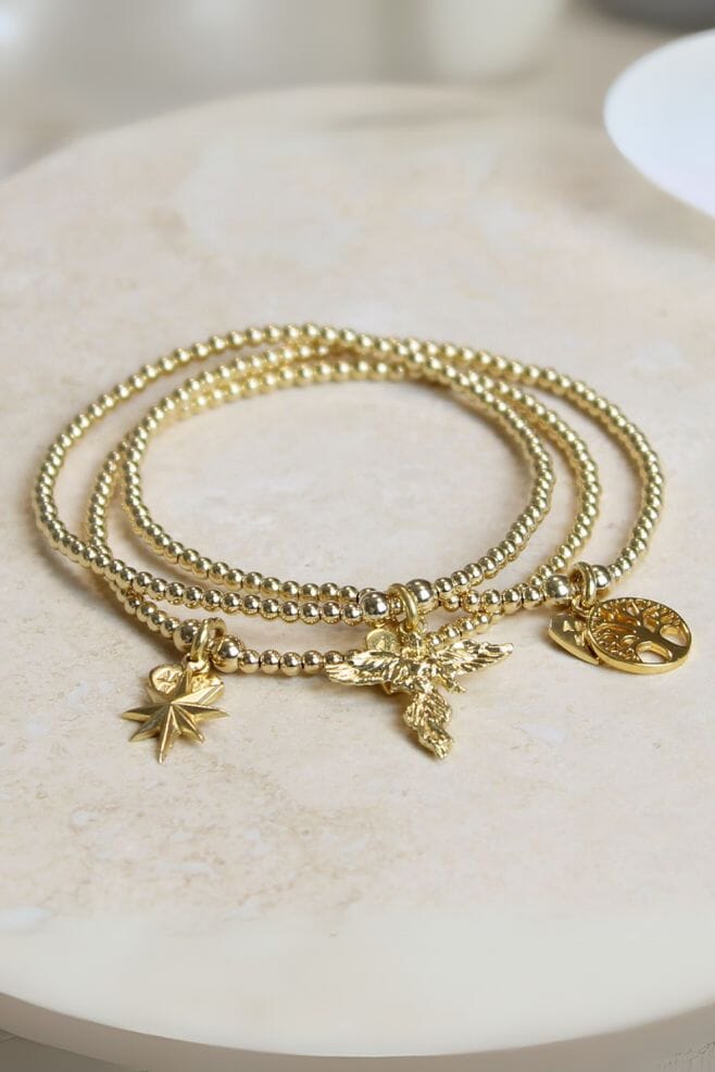 Three stand bracelet stack featuring three iconic Santeenie beaded charm bracelets.