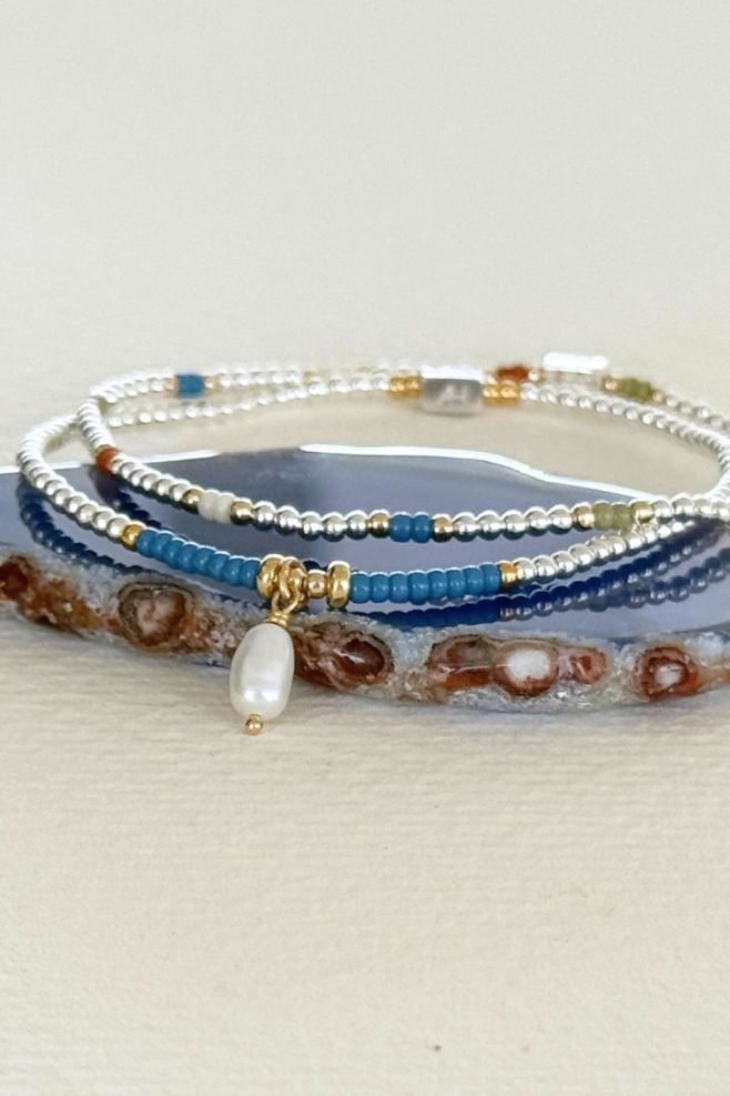 Bracelet stack made with 925 Sterling Silver, gold-plated Silver, Japanese seed beads and a Freshwater pearl charm.