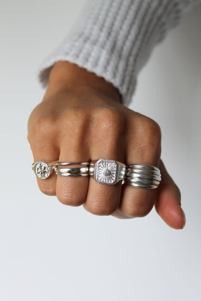 A chunky 925 Sterling Silver ring featuring a shining Sun design with a Zirconia crystal at its centre.