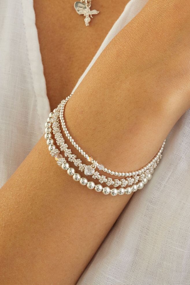 A trio of stylish and stackable Sterling Silver bracelets, featuring genuine sparkling Preciosa Crystals and a pretty Heart Crystal charm.