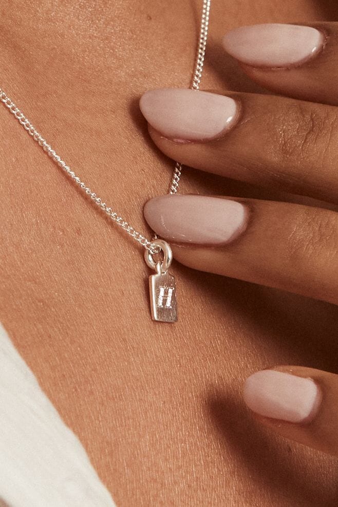 Handcrafted in 925 Sterling Silver, this necklace features a new engravable tag charm.