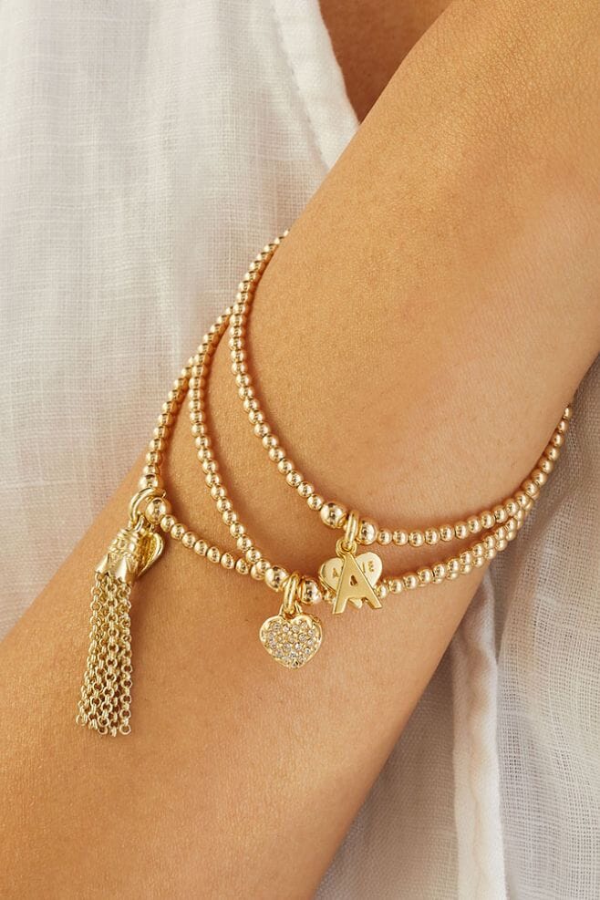 A stackable charm bracelet featuring a gold plated silver initial charm of your choice.