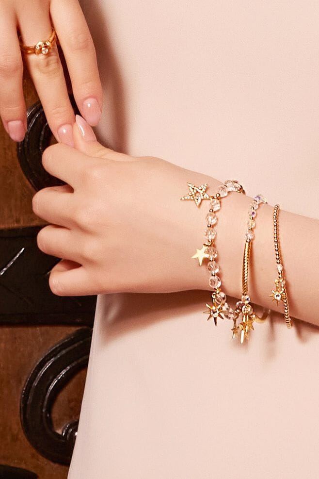 This elegant gold plated Silver bracelet is decorated with seven different Star charm designs and features Rock Crystal for that extra sparkle.