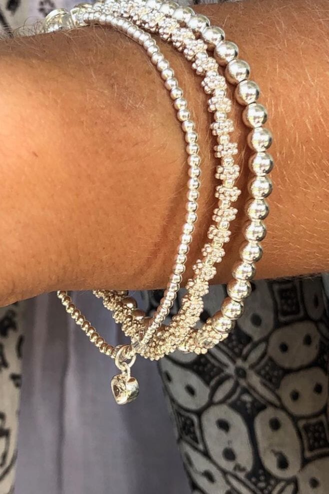 A trio of stylish and stackable Sterling Silver bracelets, featuring genuine sparkling Preciosa Crystals and a pretty Heart Crystal charm.