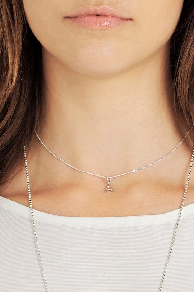 A dainty 925 Sterling Silver necklace with a choice of cute silver Tiny Initial charms.