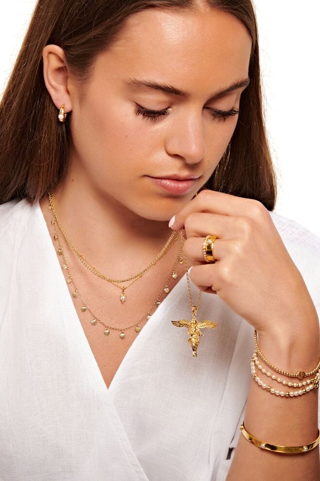 Adorned with six Preciosa Pearls for a sophisticated feel, this gold bangle is the perfect gift for a loved one or yourself.