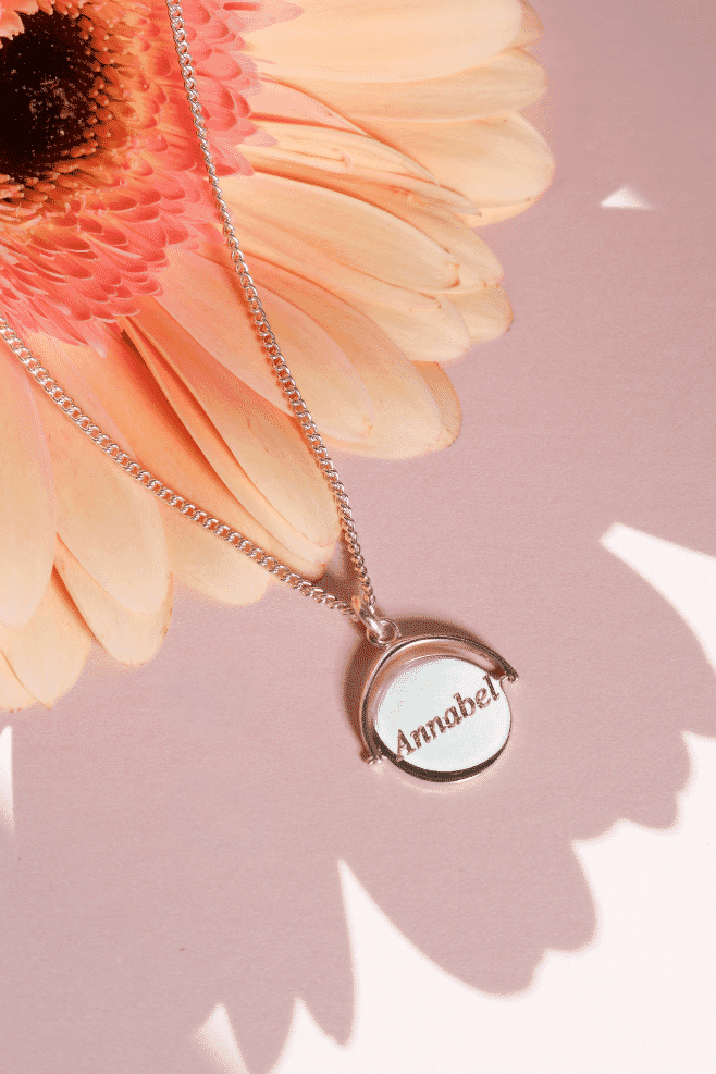 Elegant, modern, and subtly playful, the Halo Spinner Necklace features a unique rotating personalised pendant that makes it the perfect keepsake. Suspended on a delicate chain, the circular “halo” design spins freely, creating a dynamic, eye-catching ef