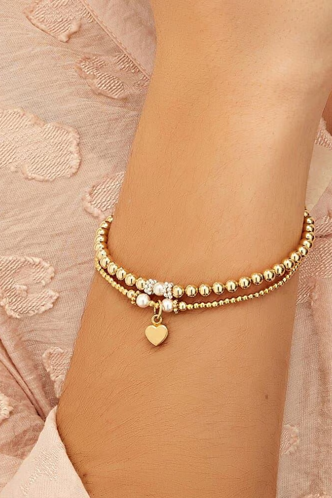 Seri and Ceremony sterling silver bracelet stack with elegant pearl detailing, handcrafted for a timeless layered look.