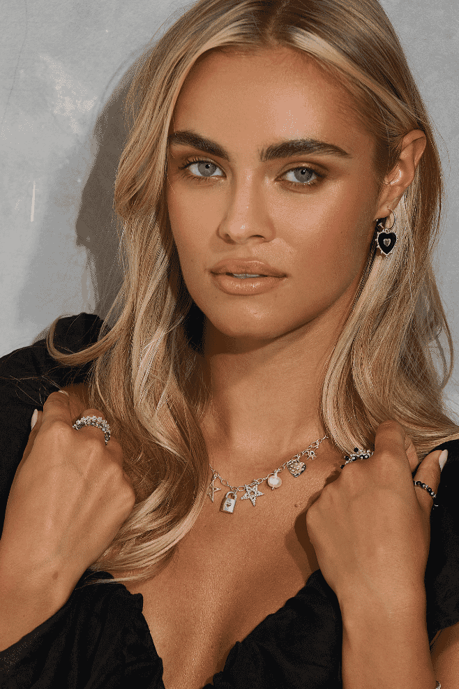 Festive charm necklace in 925 sterling silver with nine dangling charms including stars, a Lovelock, crystal heart, and My Guardian Angel, accented with pearls, zirconia crystals, and Italian enamel.