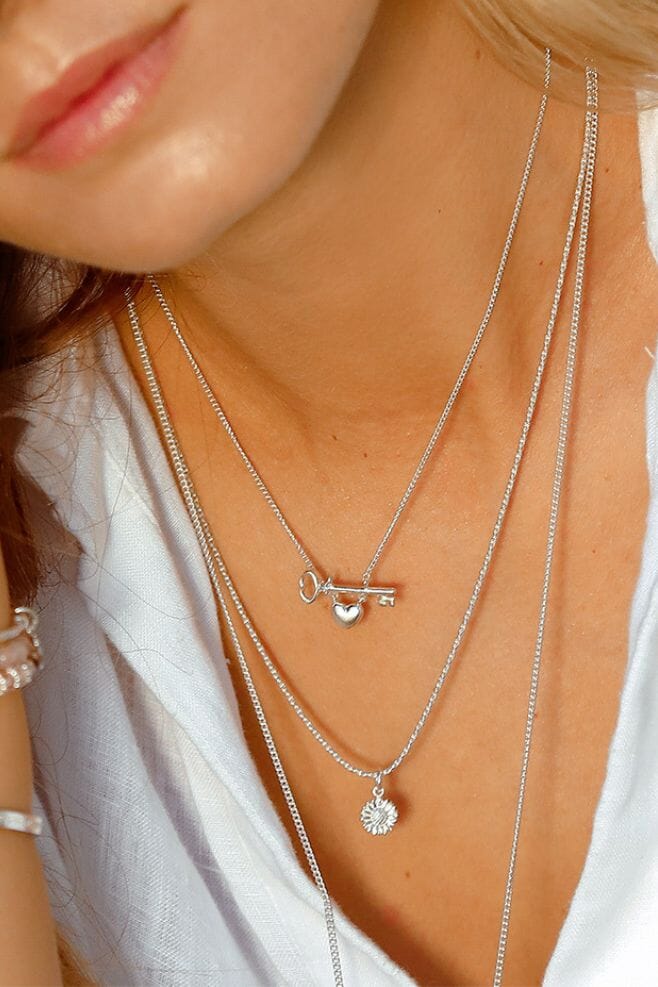 925 Sterling Silver necklace featuring a sunflower charm with an engraving on the back reading 'Love You'.