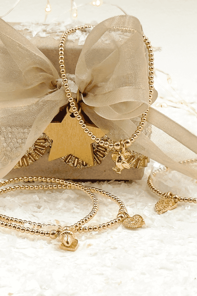 Gold plated silver santeenie charm bracelets with sparkles around it