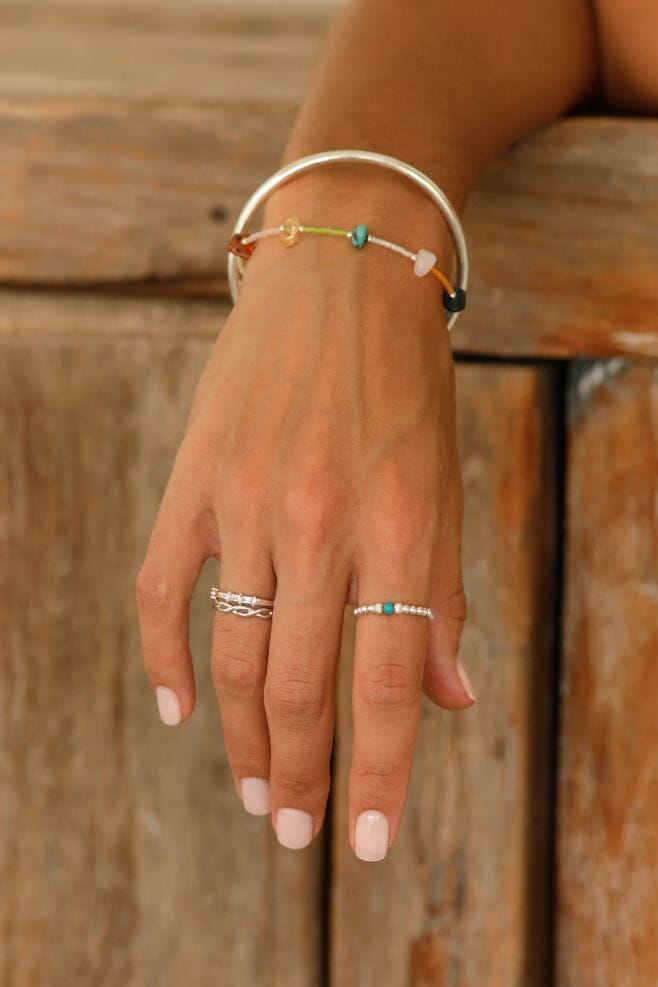 A gold-plated Silver hand-threaded beaded ring finished with a fun Turquoise Howlite gemstone.