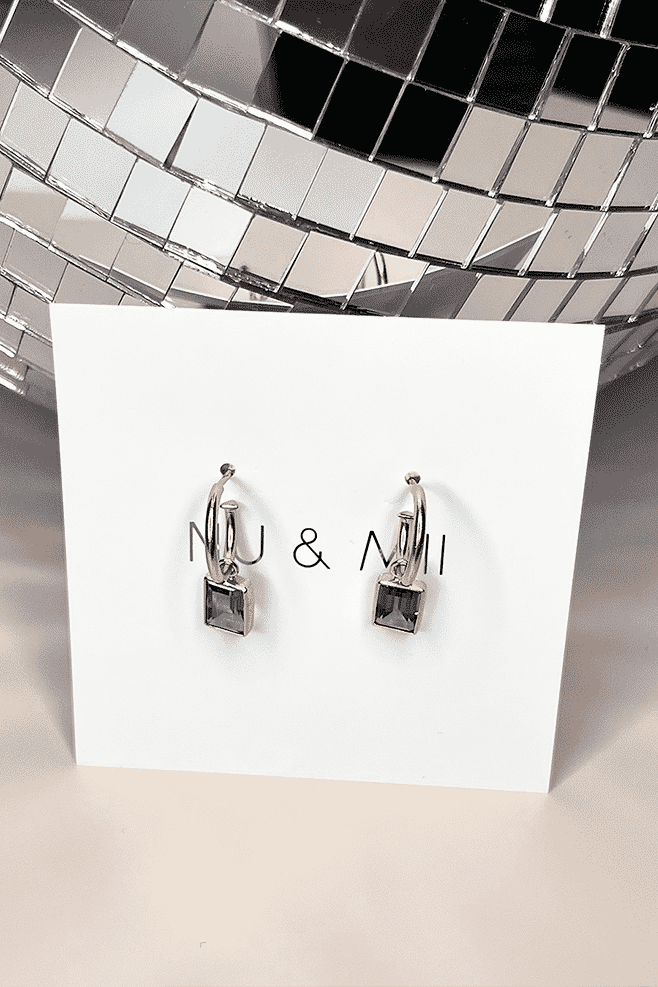 Dangling from a hoop earring is a genuine Green Quartz gemstone wrapped in gold plated Sterling Silver.