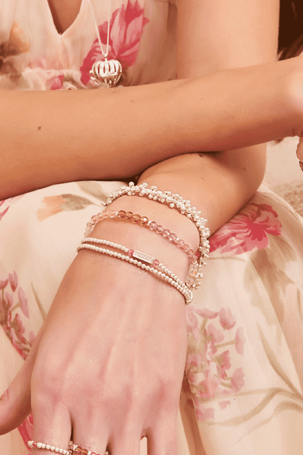 Add a touch of colour and elegance to your wrist with our Rose Phoebe Looped Personalised Bracelet. This beautiful bracelet features two loops of gold-plated silver intertwined with rose Preciosa crystals