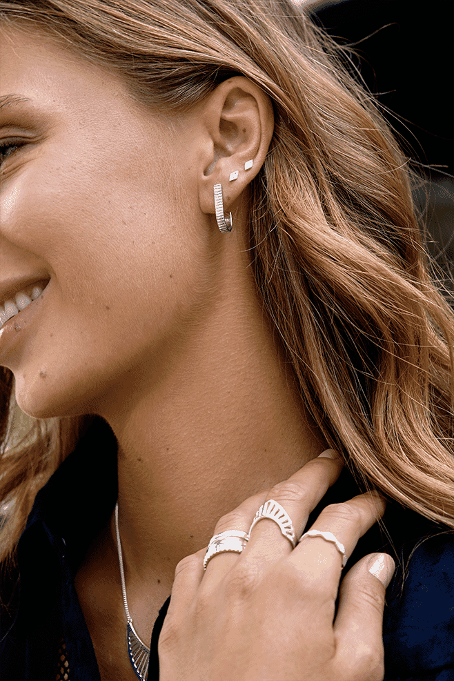 Unlike traditional hoop earrings these are oblong in shape and are finished with a ribbed, engraved detail.