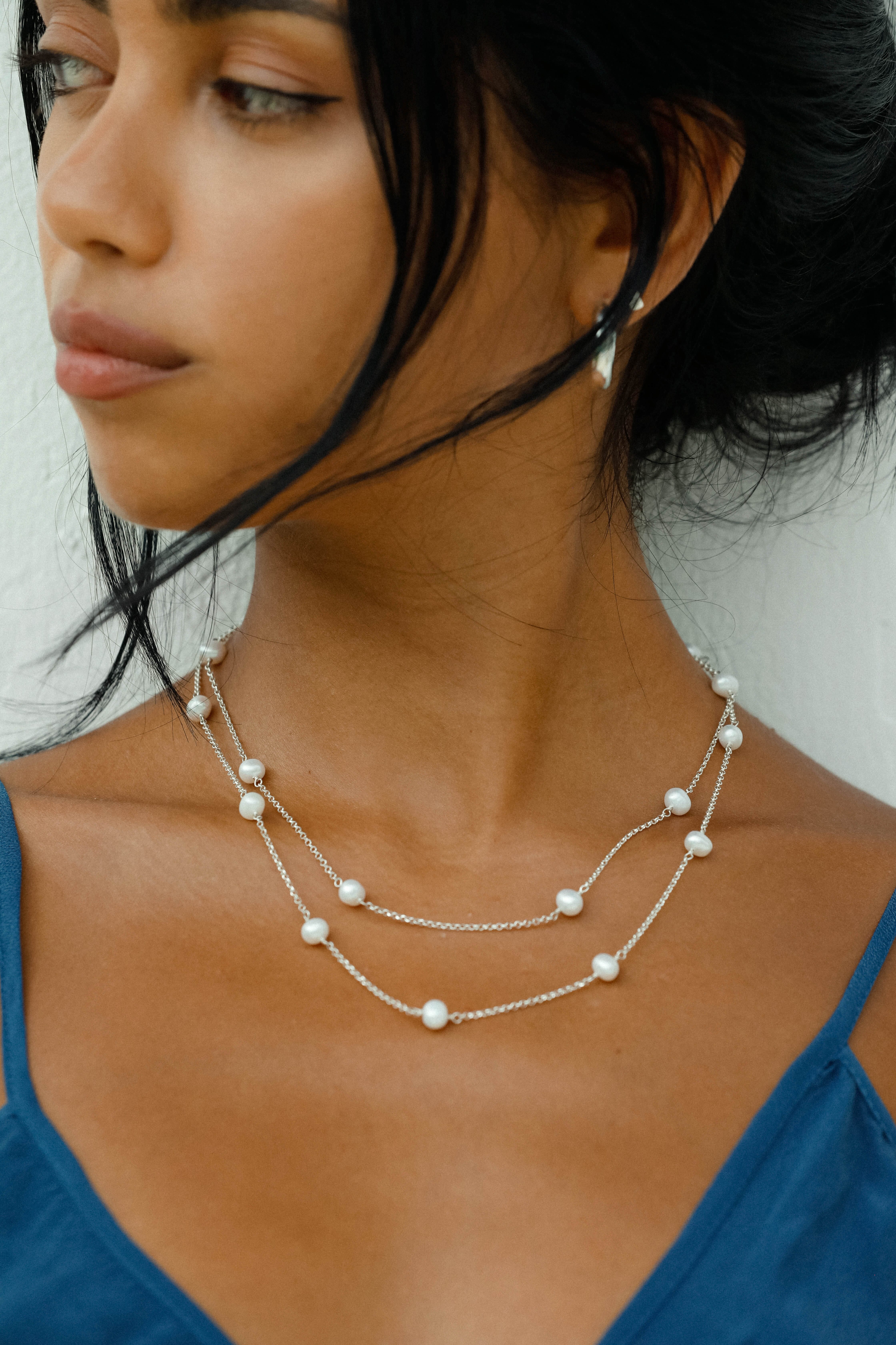 The necklace is a 925 silver duo chain, handcrafted featuring stunning Freshwater Pearls.